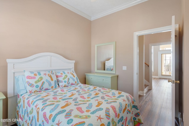 bedroom featuring ornamental molding and dark hardwood / wood-style floors