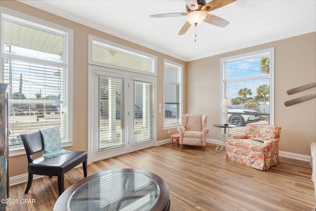 sitting room featuring crown molding, light hardwood / wood-style floors, and ceiling fan