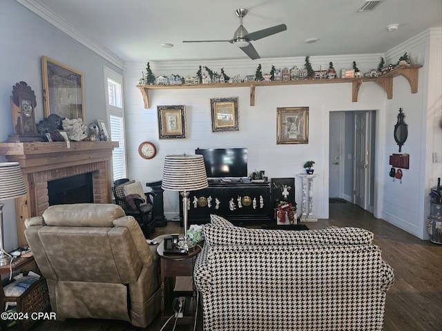 living room featuring a brick fireplace, ceiling fan, dark hardwood / wood-style floors, and crown molding