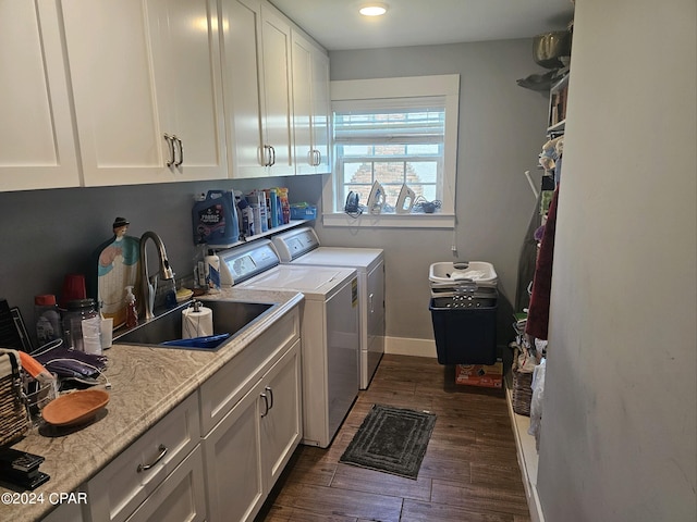 laundry room with cabinets, sink, dark hardwood / wood-style floors, and washer and dryer