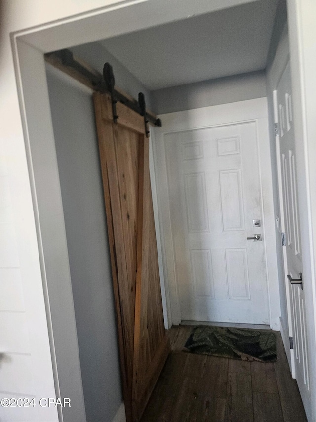 doorway to outside with wood-type flooring and a barn door