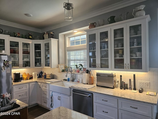 kitchen with decorative light fixtures, white cabinetry, stainless steel appliances, light stone countertops, and crown molding