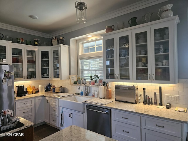 kitchen featuring light stone counters, white cabinets, appliances with stainless steel finishes, and crown molding