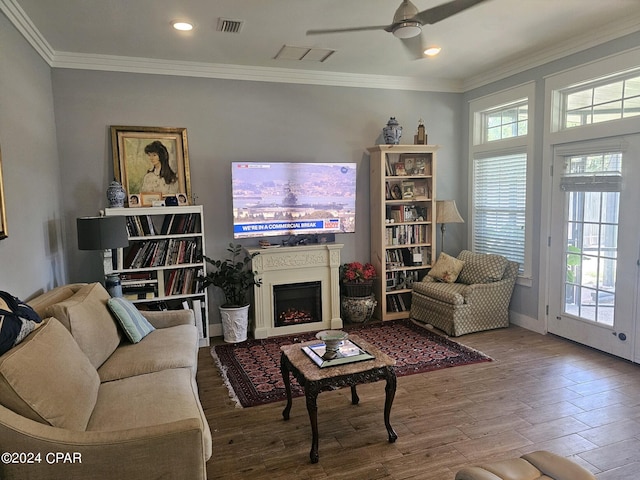 living room with ornamental molding, ceiling fan, and hardwood / wood-style floors