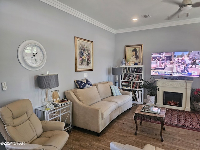 living room with crown molding, dark hardwood / wood-style floors, and ceiling fan