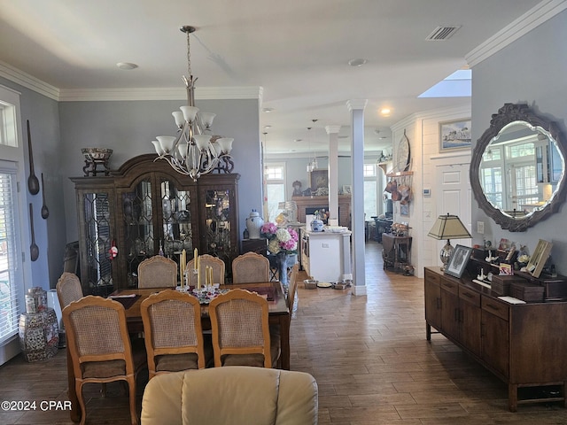 dining room featuring ornamental molding, dark wood-type flooring, ornate columns, and a wealth of natural light