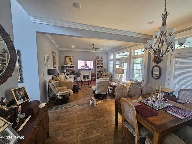 dining space featuring ceiling fan with notable chandelier, dark hardwood / wood-style floors, and crown molding