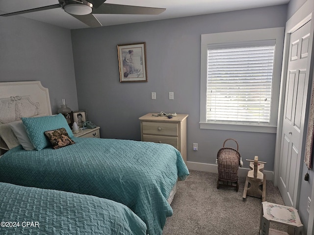 bedroom featuring light carpet, ceiling fan, and a closet