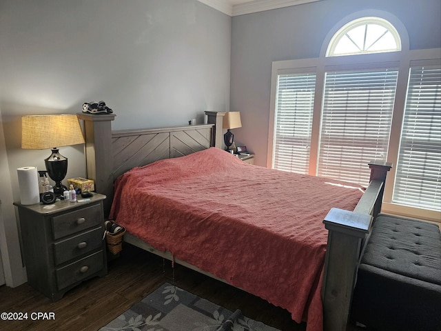 bedroom featuring dark hardwood / wood-style flooring and crown molding