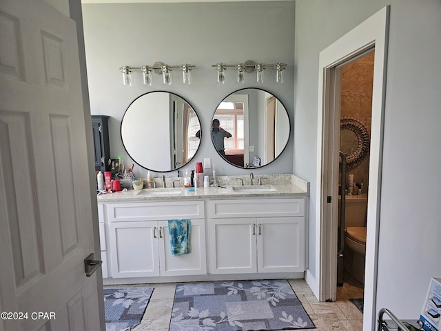 bathroom featuring vanity, toilet, and tile patterned floors