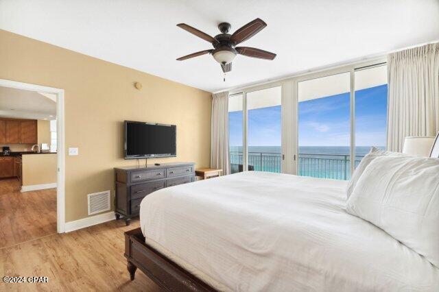 bedroom featuring access to outside, ceiling fan, and light wood-type flooring