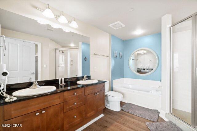 bathroom featuring vanity, shower with separate bathtub, and hardwood / wood-style floors