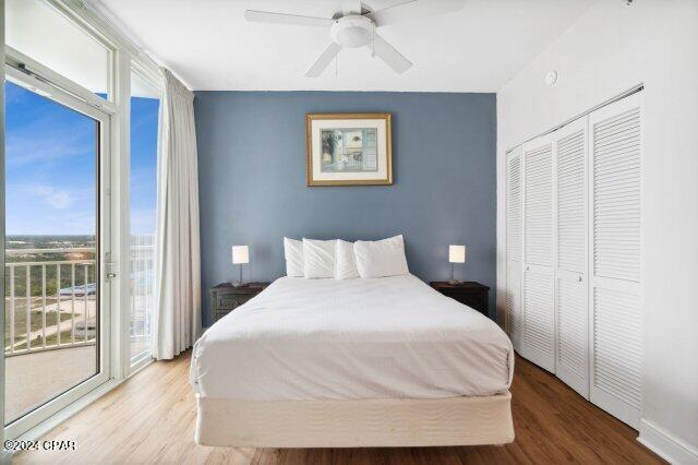 bedroom featuring ceiling fan, access to exterior, hardwood / wood-style floors, and a closet