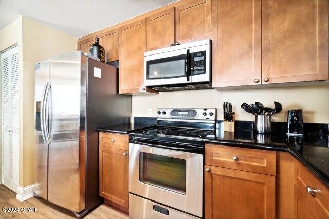 kitchen featuring stainless steel appliances and light hardwood / wood-style floors