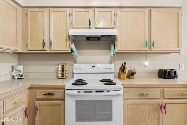 kitchen with under cabinet range hood, light brown cabinets, white range with electric stovetop, and light countertops