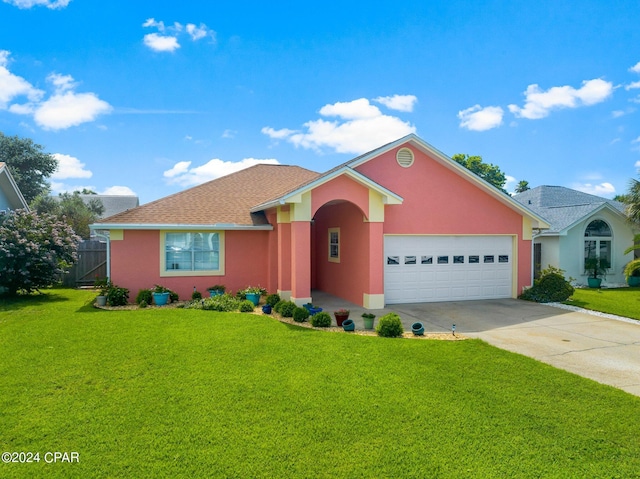 ranch-style home featuring a garage and a front lawn