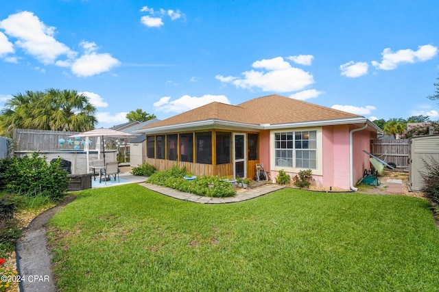 back of property featuring stucco siding, a lawn, a sunroom, a patio area, and fence