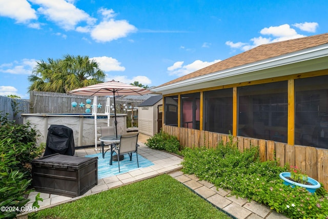 view of yard with a sunroom, fence, a fenced in pool, and a patio