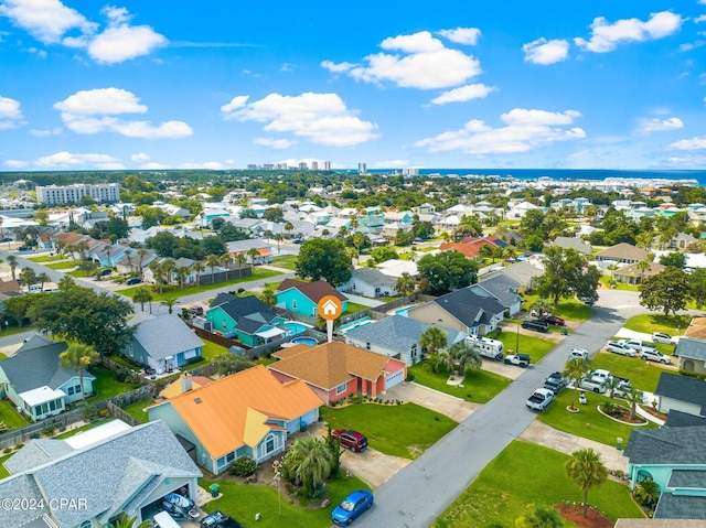 drone / aerial view with a residential view and a water view