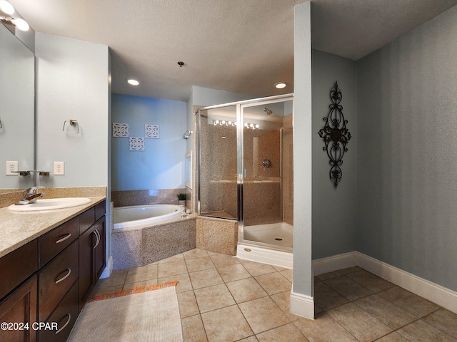 bathroom featuring vanity, tile patterned floors, a textured ceiling, and shower with separate bathtub