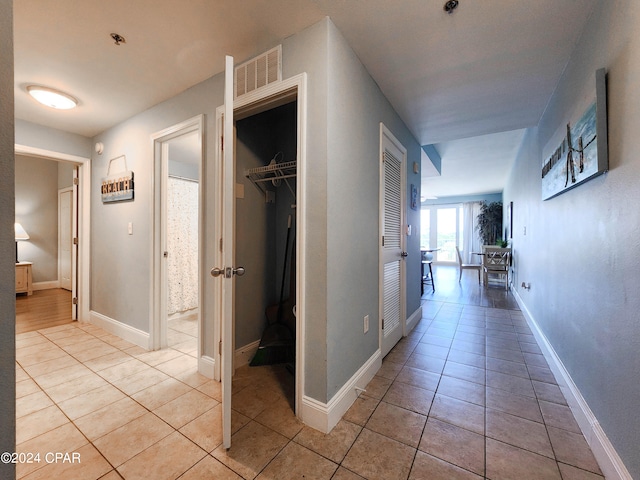 corridor with light tile patterned floors