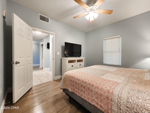 bedroom featuring ceiling fan and light hardwood / wood-style flooring