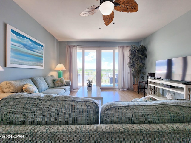 living room featuring ceiling fan and light hardwood / wood-style floors