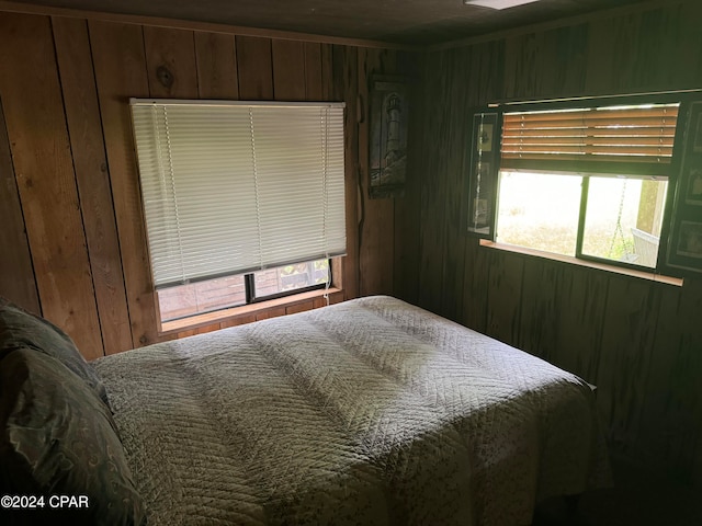 bedroom with wood walls