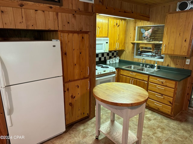 kitchen featuring sink, decorative backsplash, light tile patterned floors, and white appliances