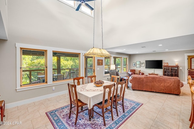 tiled dining area with a towering ceiling