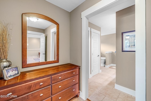 hallway featuring light tile patterned floors