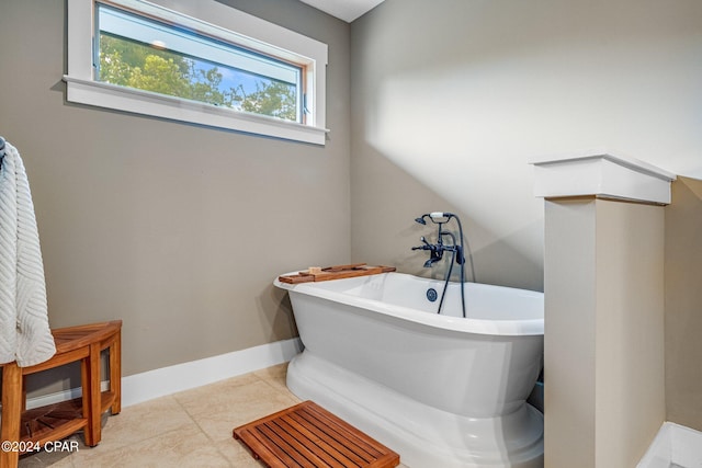 bathroom featuring tile patterned floors and a bath