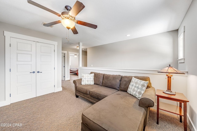 carpeted living room featuring ceiling fan