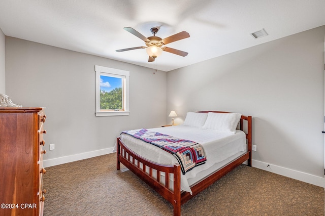 bedroom with ceiling fan and dark colored carpet