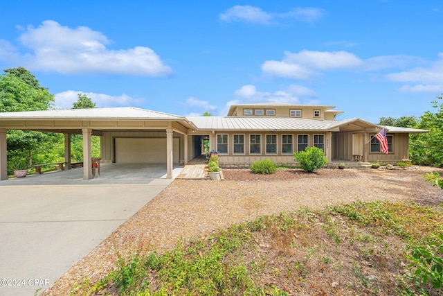 view of front of property featuring a carport and a garage