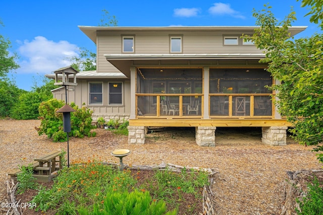 back of house featuring a sunroom