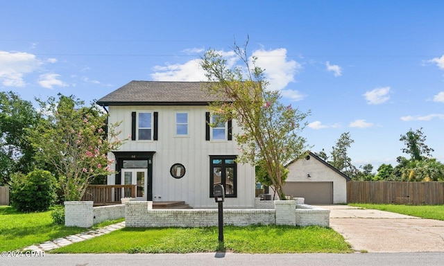 view of front of property with an outdoor structure, a garage, and a front yard