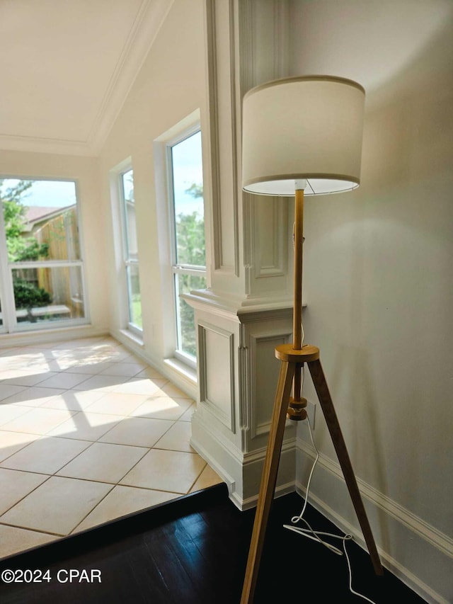 interior space with vaulted ceiling, hardwood / wood-style floors, crown molding, and plenty of natural light