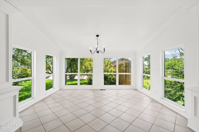 unfurnished sunroom with lofted ceiling, a healthy amount of sunlight, and a chandelier