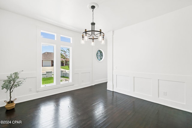 unfurnished dining area with dark wood-type flooring and a notable chandelier