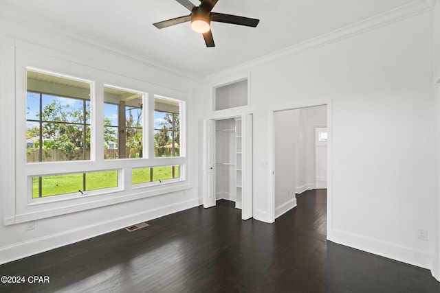 unfurnished bedroom with dark wood-type flooring, ceiling fan, and multiple windows