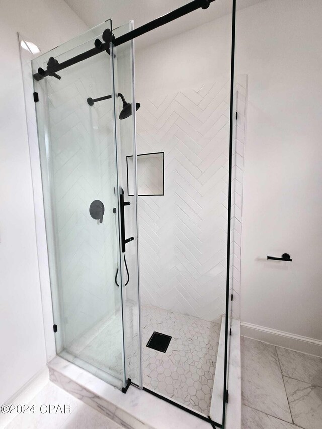 bathroom with tile patterned floors and an enclosed shower