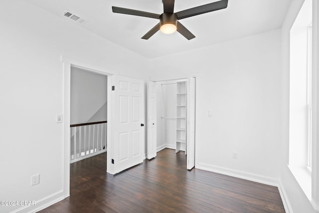 unfurnished bedroom featuring dark hardwood / wood-style flooring, a closet, and ceiling fan