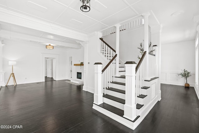 stairs with dark hardwood / wood-style flooring and ornate columns