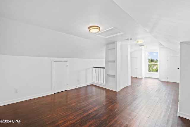 bonus room featuring dark hardwood / wood-style flooring and vaulted ceiling