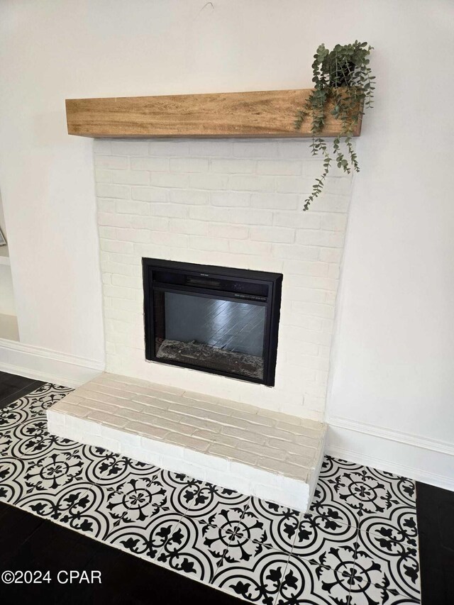 interior details featuring tile patterned flooring and a brick fireplace