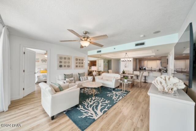 living room featuring ceiling fan and light hardwood / wood-style floors