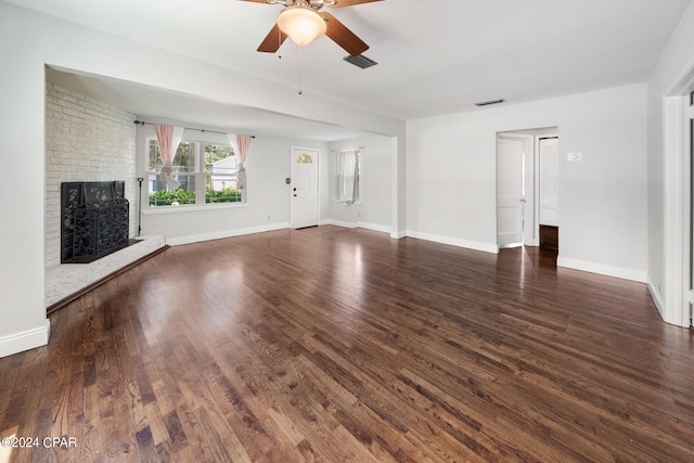 unfurnished living room featuring hardwood / wood-style floors, ceiling fan, and a fireplace