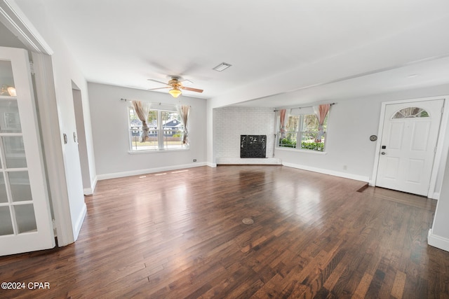 unfurnished living room with ceiling fan, wood-type flooring, and a fireplace