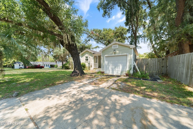 view of front of property featuring a garage and a front yard